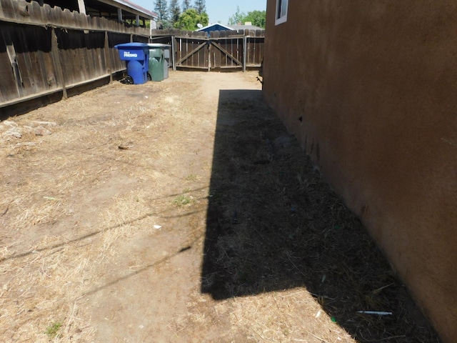 view of yard with fence and a gate