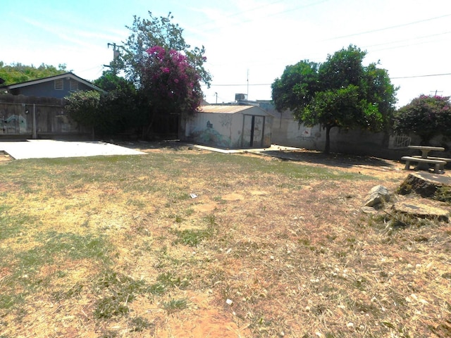 view of yard featuring fence and a patio