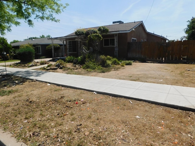 single story home featuring fence