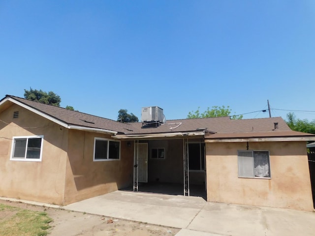 back of property featuring stucco siding, a patio, and cooling unit