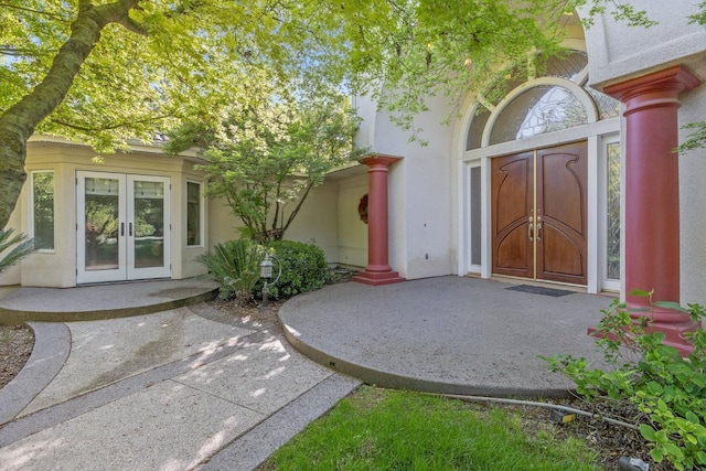property entrance with french doors and stucco siding