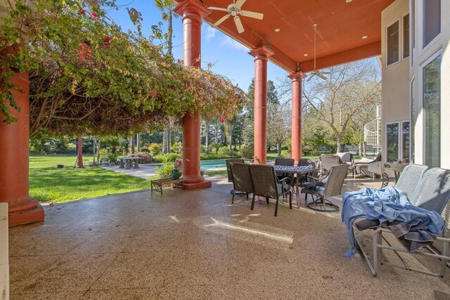view of patio / terrace featuring outdoor dining area, an outdoor pool, and ceiling fan