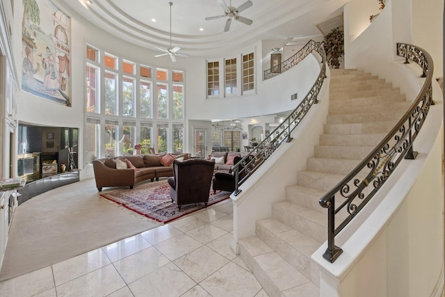 interior space featuring recessed lighting, a high ceiling, marble finish floor, visible vents, and a ceiling fan