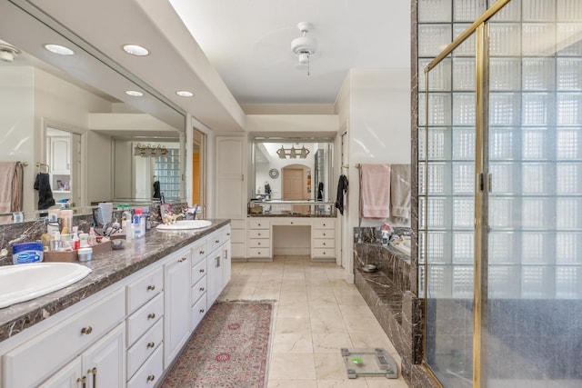 full bath featuring a sink, recessed lighting, double vanity, and a bathing tub