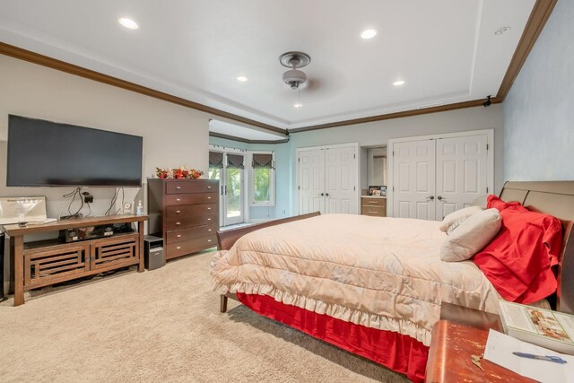 carpeted bedroom featuring crown molding, multiple closets, and recessed lighting