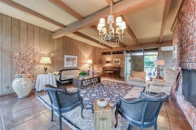 living area featuring beamed ceiling, wooden walls, a fireplace, and an inviting chandelier