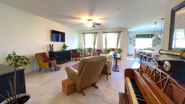 living room featuring a ceiling fan and a healthy amount of sunlight