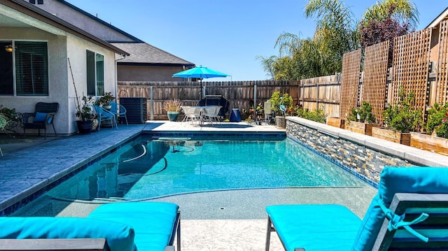 view of swimming pool with a patio area, a fenced in pool, and a fenced backyard