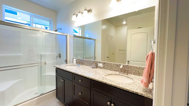 full bathroom with a sink, double vanity, and a stall shower