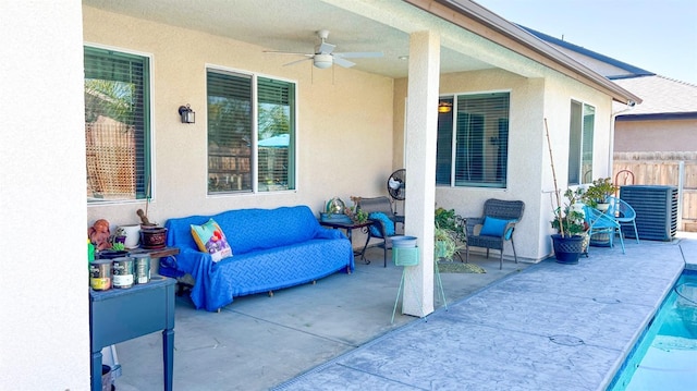 view of patio / terrace featuring central AC unit, fence, outdoor lounge area, ceiling fan, and an outdoor pool