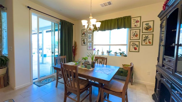dining space featuring visible vents, baseboards, and a notable chandelier