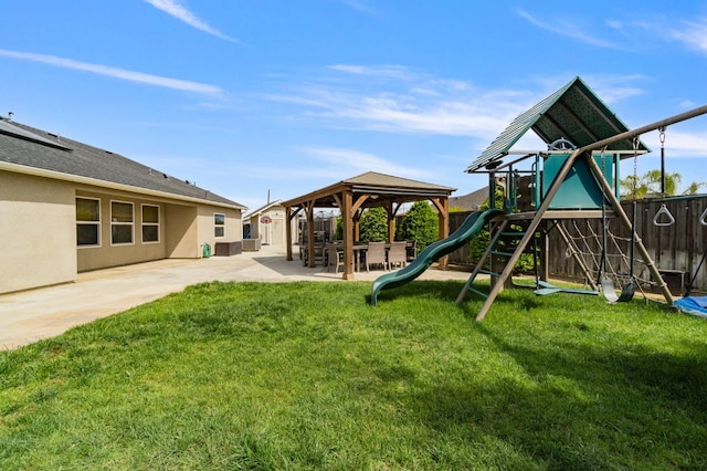 view of playground with a yard, a patio, and fence