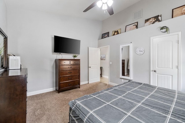 bedroom with baseboards, visible vents, carpet, lofted ceiling, and a ceiling fan
