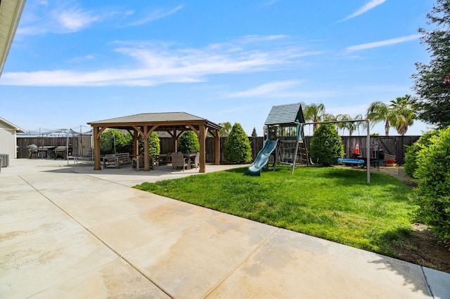 view of playground with a patio area, a fenced backyard, a gazebo, and a yard