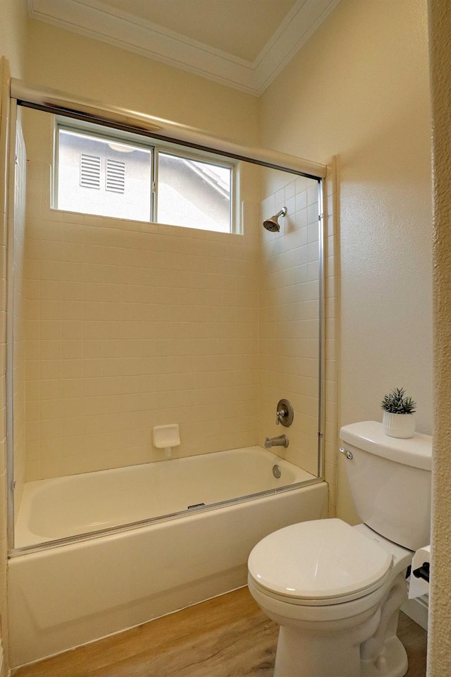 full bathroom with crown molding, toilet, a wealth of natural light, and wood finished floors