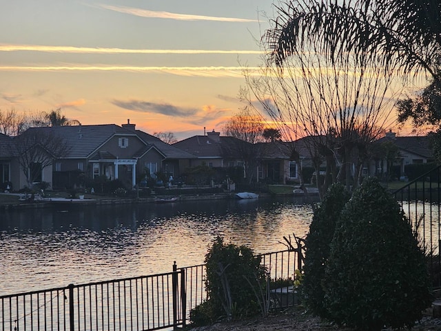 view of water feature featuring a residential view and fence