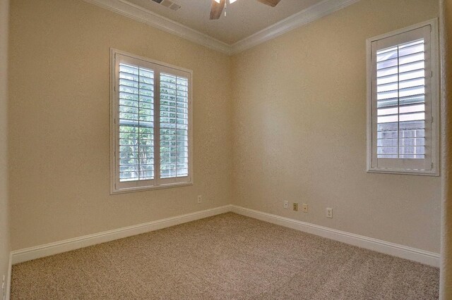 unfurnished room featuring ceiling fan, baseboards, ornamental molding, and carpet flooring