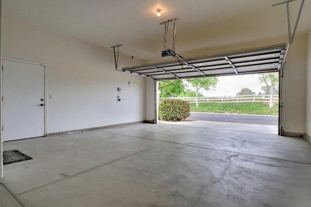 garage with baseboards and a garage door opener