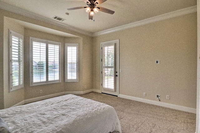 bedroom with visible vents, crown molding, baseboards, and multiple windows