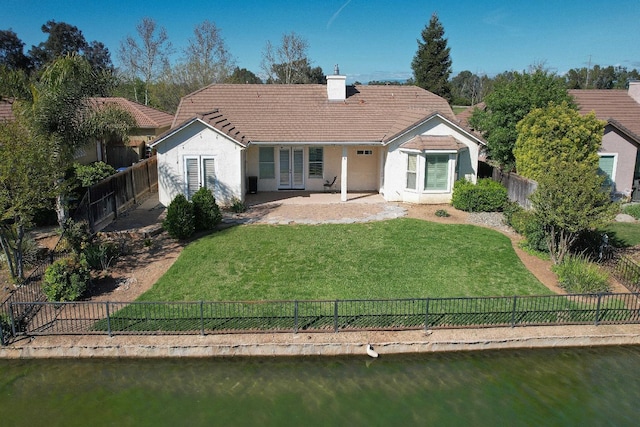 back of house featuring stucco siding, a patio area, french doors, and a fenced backyard