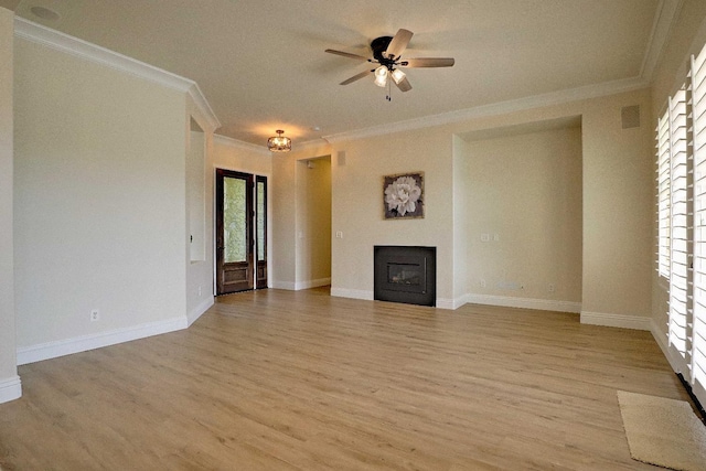 unfurnished living room featuring light wood finished floors, plenty of natural light, and ornamental molding
