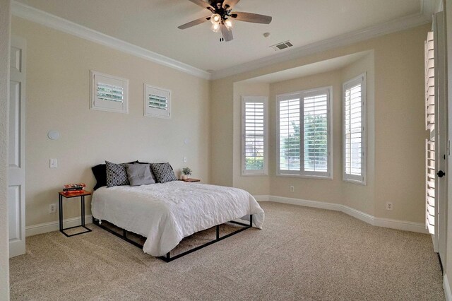 bedroom featuring baseboards, visible vents, ornamental molding, and light carpet
