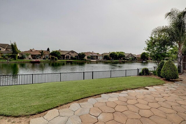 view of water feature featuring fence and a residential view
