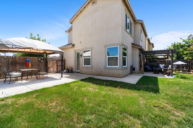 rear view of house with a patio, a pergola, stucco siding, and an outdoor hangout area