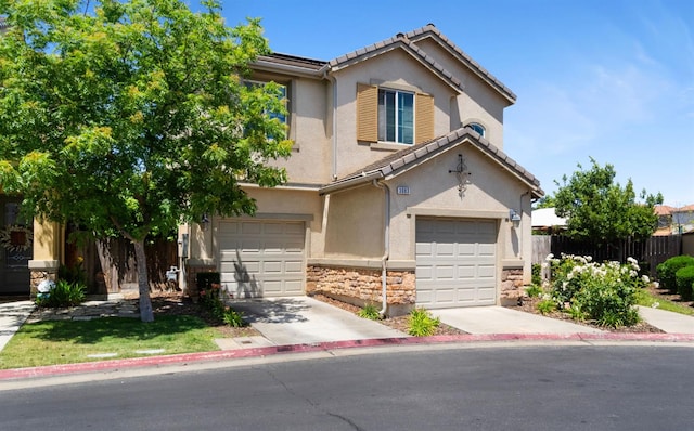 view of front of home with stone siding, stucco siding, a garage, driveway, and fence