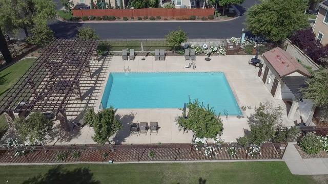 community pool featuring fence and a patio area