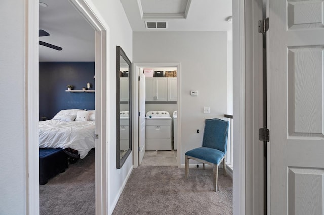 corridor featuring carpet and washer and dryer