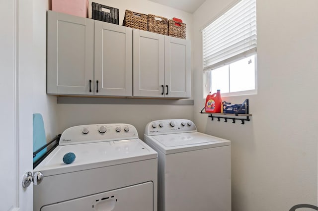 laundry area with washing machine and dryer and cabinet space