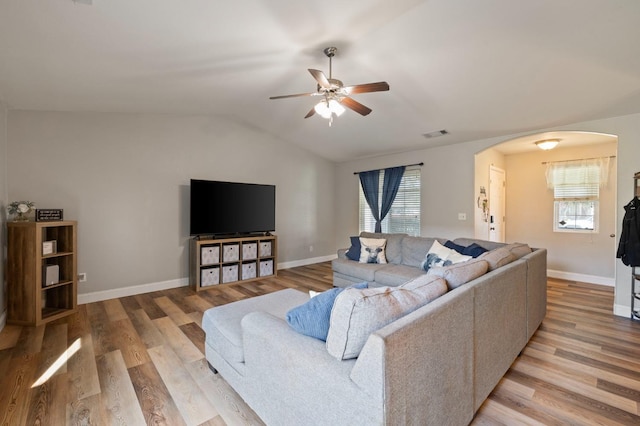 6675 E Montecito Ave, Fresno, CA 93727 - living area featuring arched walkways, a healthy amount of sunlight, light wood finished floors, and ceiling fan