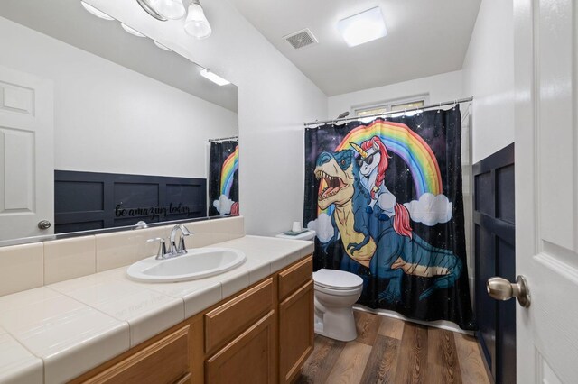 6675 E Montecito Ave, Fresno, CA 93727 - bathroom featuring toilet, visible vents, wood finished floors, a shower with shower curtain, and vanity