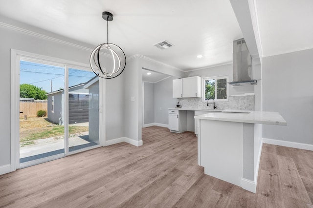 4731 E Laurel Ave, Fresno, CA 93702 - kitchen featuring exhaust hood, a sink, light countertops, a peninsula, and tasteful backsplash