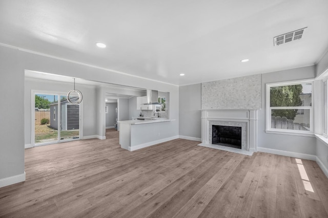4731 E Laurel Ave, Fresno, CA 93702 - unfurnished living room with a fireplace with flush hearth, baseboards, light wood finished floors, and recessed lighting