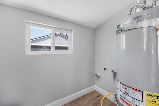 4731 E Laurel Ave, Fresno, CA 93702 - washroom featuring gas water heater, electric dryer hookup, wood finished floors, and baseboards