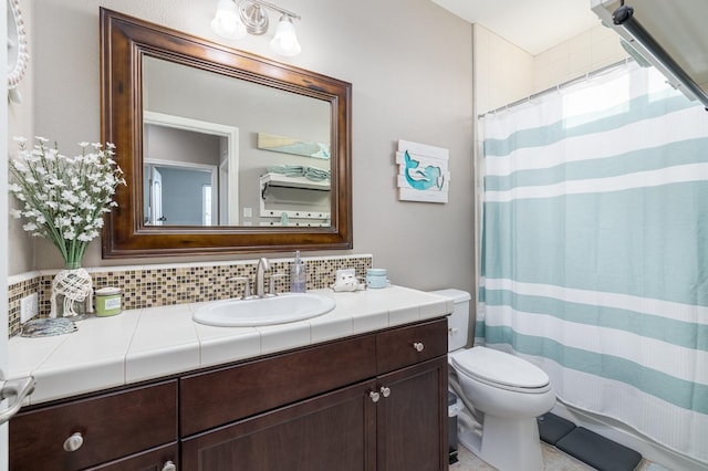 bathroom featuring backsplash, toilet, a shower with shower curtain, and vanity