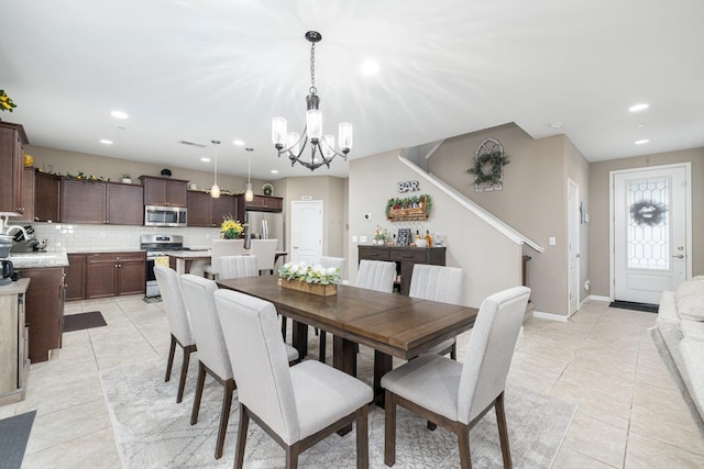 dining room featuring light tile patterned floors, recessed lighting, and a chandelier