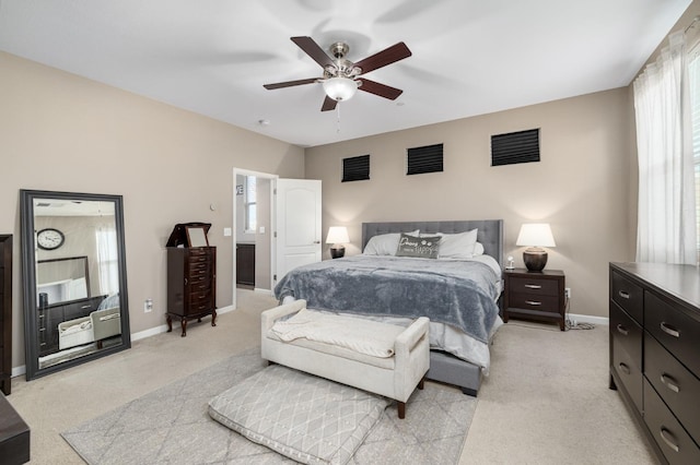 bedroom with baseboards, light carpet, a ceiling fan, and visible vents