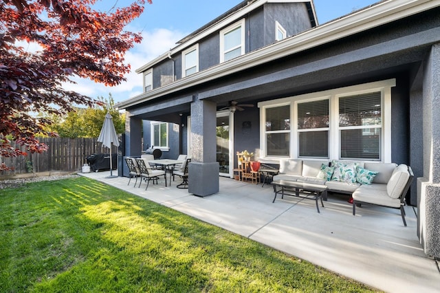back of house featuring a yard, fence, a patio area, and stucco siding