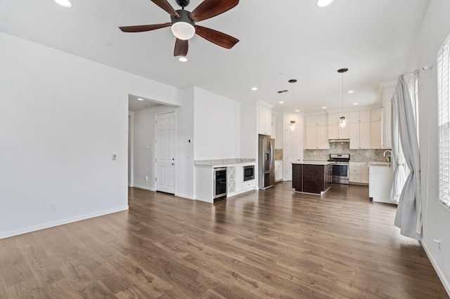 2067 E Axelson Dr, Fresno, CA 93730 - unfurnished living room featuring recessed lighting, dark wood-type flooring, wine cooler, and ceiling fan
