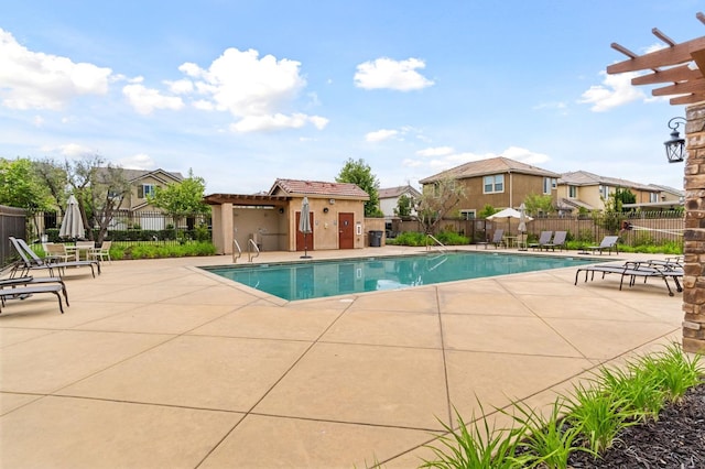 2067 E Axelson Dr, Fresno, CA 93730 - pool featuring a patio area, fence, and a residential view