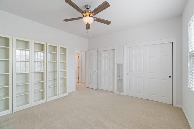 2067 E Axelson Dr, Fresno, CA 93730 - unfurnished bedroom with baseboards, multiple closets, ceiling fan, and light carpet