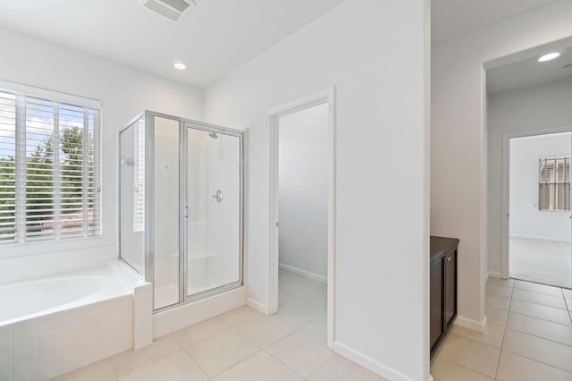2067 E Axelson Dr, Fresno, CA 93730 - bathroom featuring a bath, visible vents, tile patterned flooring, and a stall shower