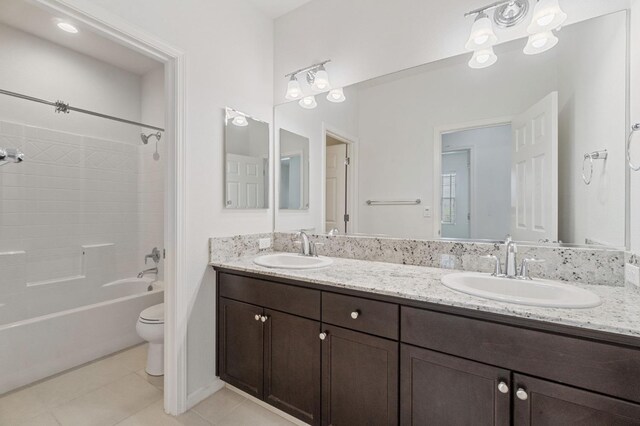 2067 E Axelson Dr, Fresno, CA 93730 - full bath with double vanity, toilet, a sink, and tile patterned flooring
