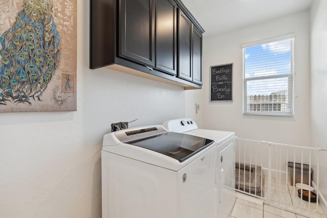 3821 Leigh Ln, Clovis, CA 93619 - washroom featuring washer and clothes dryer, light tile patterned floors, and cabinet space