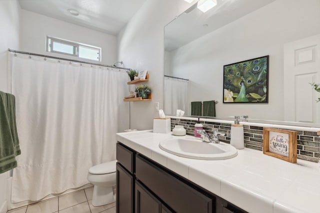 3821 Leigh Ln, Clovis, CA 93619 - full bathroom with tile patterned flooring, toilet, vanity, a shower with shower curtain, and tasteful backsplash