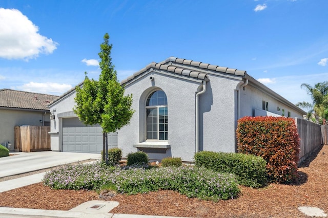 3821 Leigh Ln, Clovis, CA 93619 - view of front of property featuring a garage, stucco siding, driveway, and fence