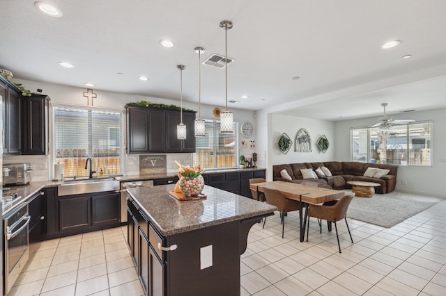 3821 Leigh Ln, Clovis, CA 93619 - kitchen with visible vents, oven, a wealth of natural light, and a sink
